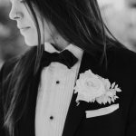 a bride wearing a black suit