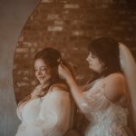 Bride pinning hearts into her bride's hair