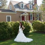 Bride standing in the front of the historic manor
