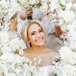 a bride with white flowers surrounding her face