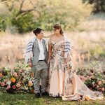 two Jewish brides posing at their wedding ceremony