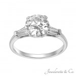 1.26 carat round center diamond with a traditional baguette side setting