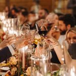 A romantic photo of a toast with glasses during a wedding reception