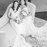 two brides posting on a chair together