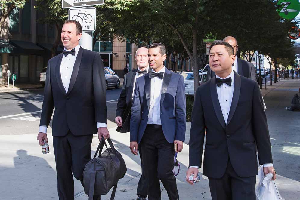 gay groom with wedding attendants