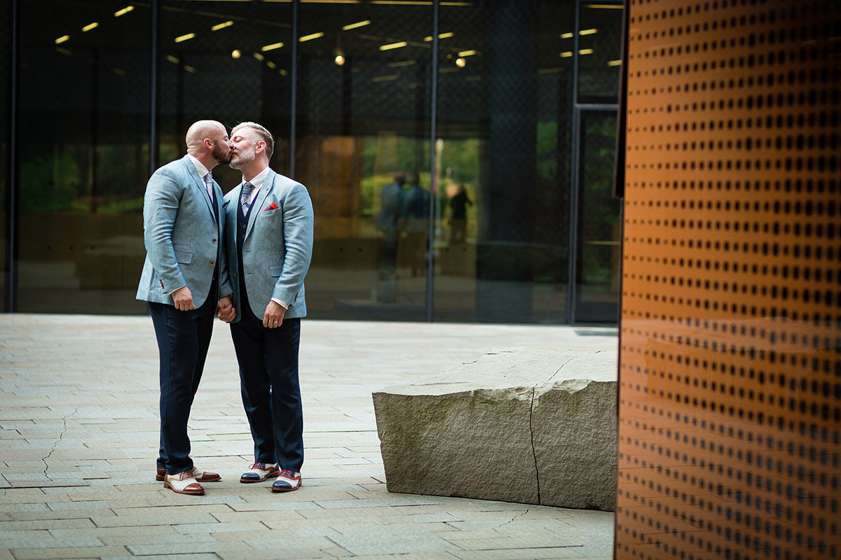 Artistic Wedding in the DeYoung Museum in San Francisco, California kiss two grooms