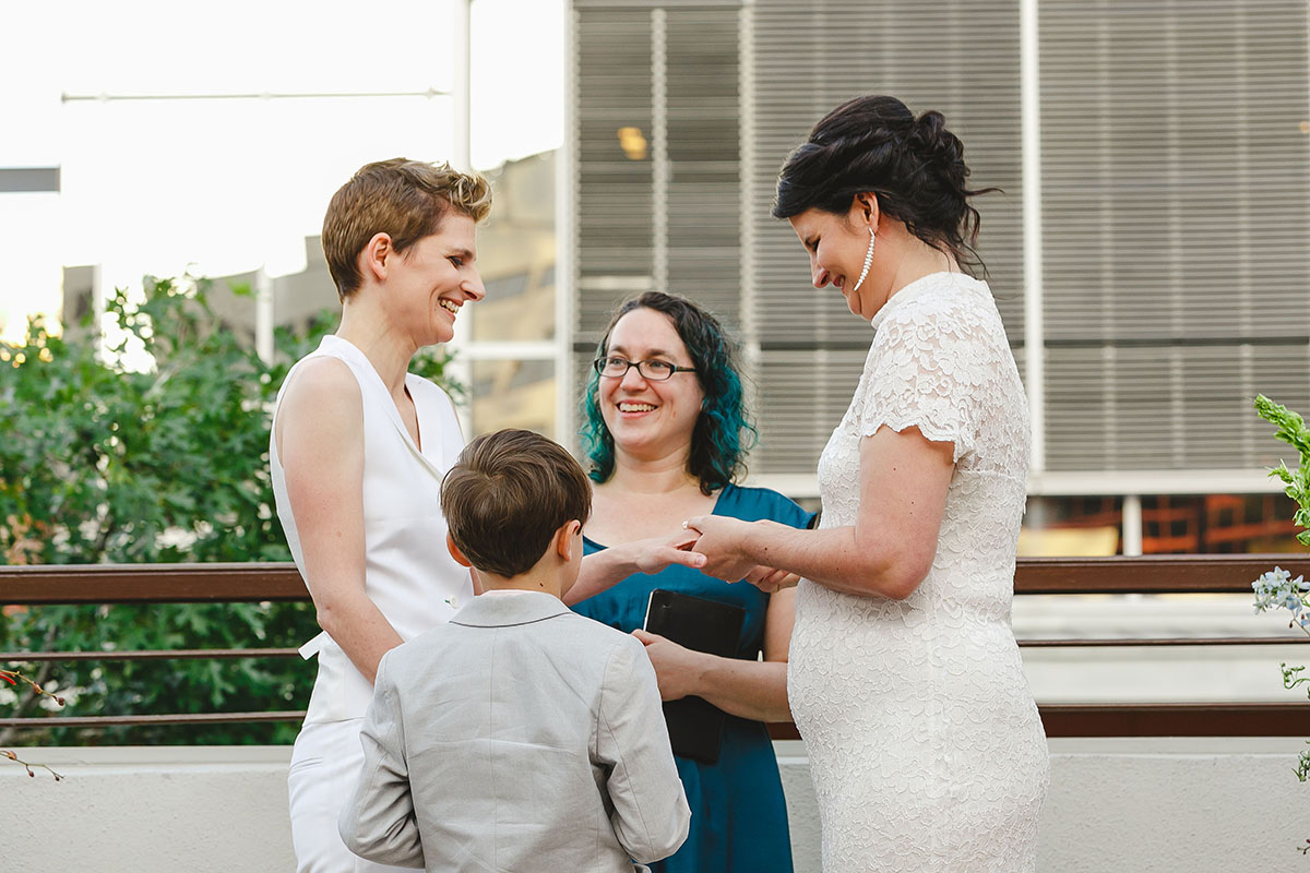 Colorful outdoor rooftop lesbian wedding in Austin, Texas vows
