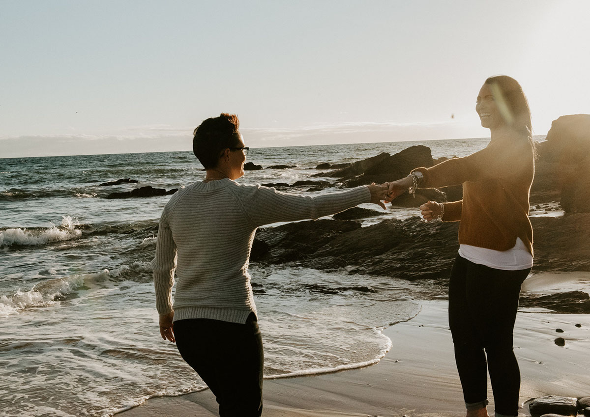 Same-sex engagement photography session on the coast of South Australia sunset dance