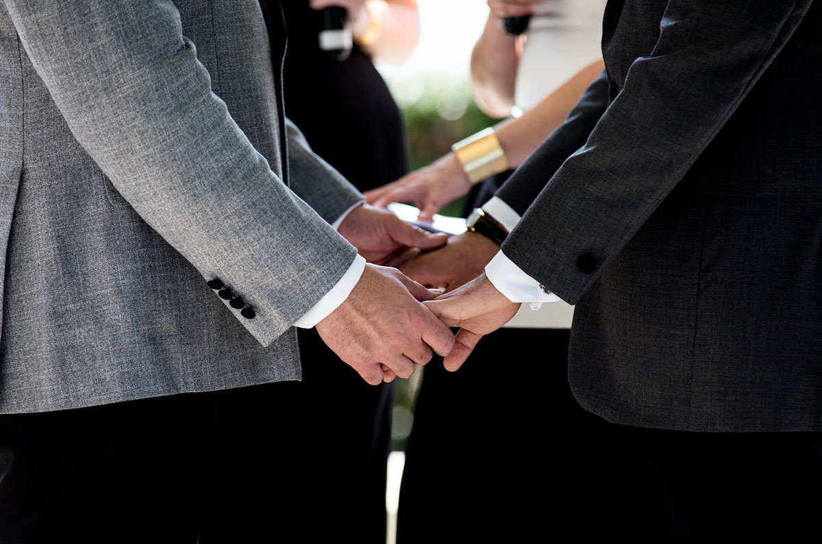 Gay wedding in Puerto Vallarta, Mexico holding hands intimate