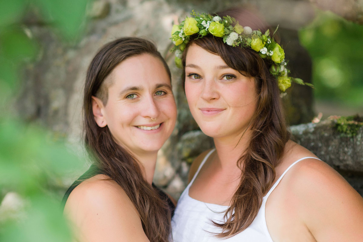 Lesbian wedding with summer garden and creative floral bouquets brides