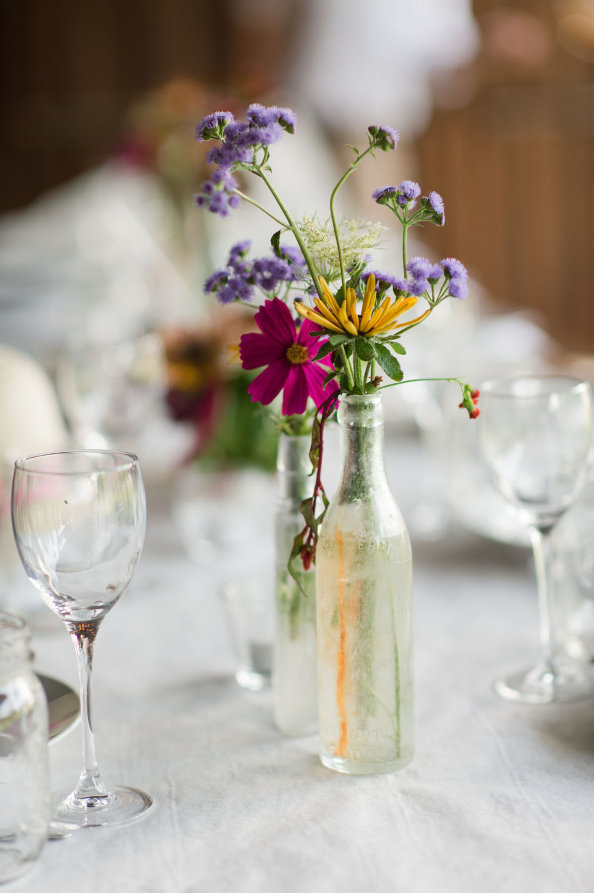 Lesbian wedding with summer garden and creative floral bouquets floral centerpiece