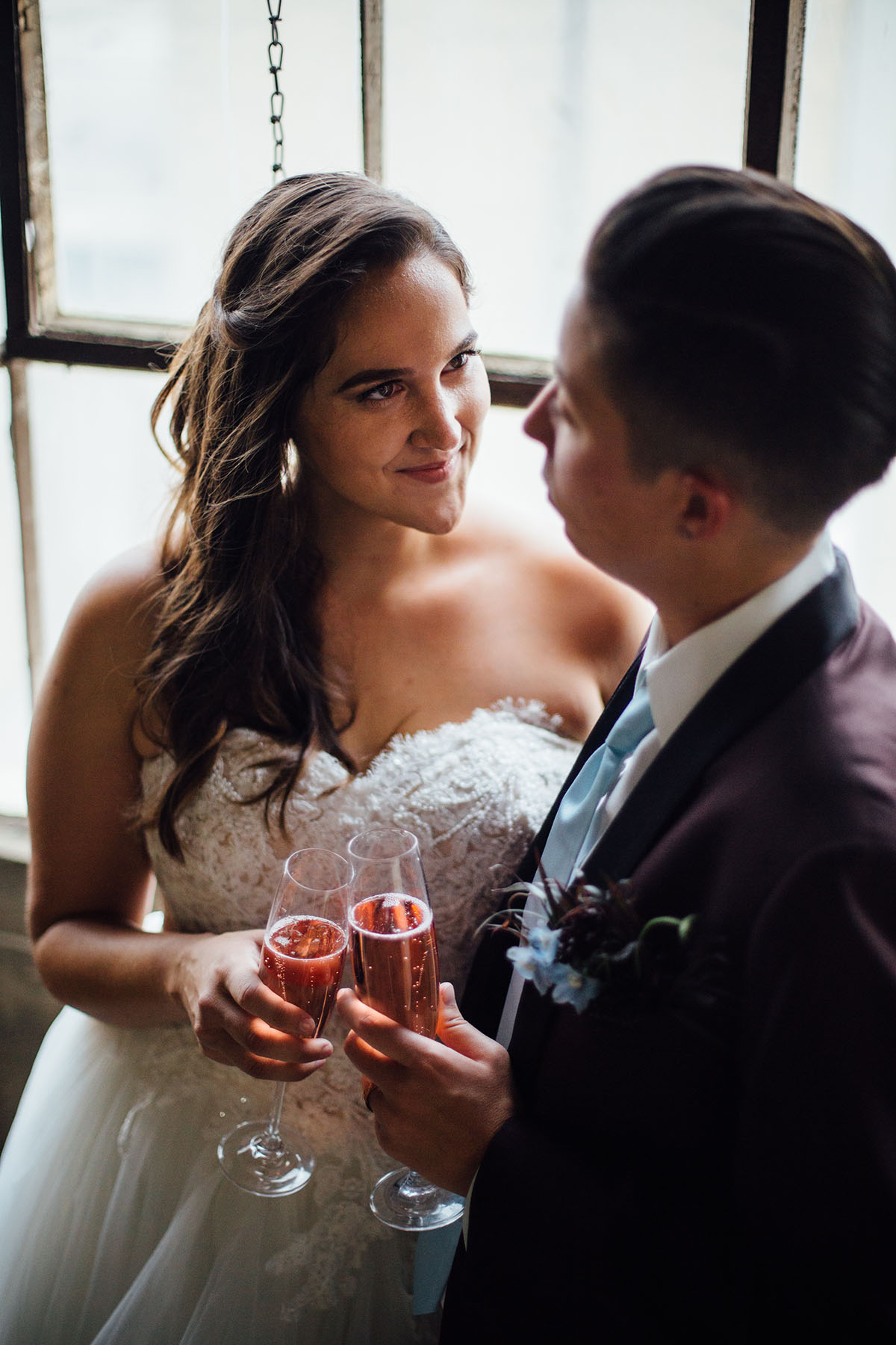 Pop-up styled lesbian wedding shoot in grays and blues champagne celebration