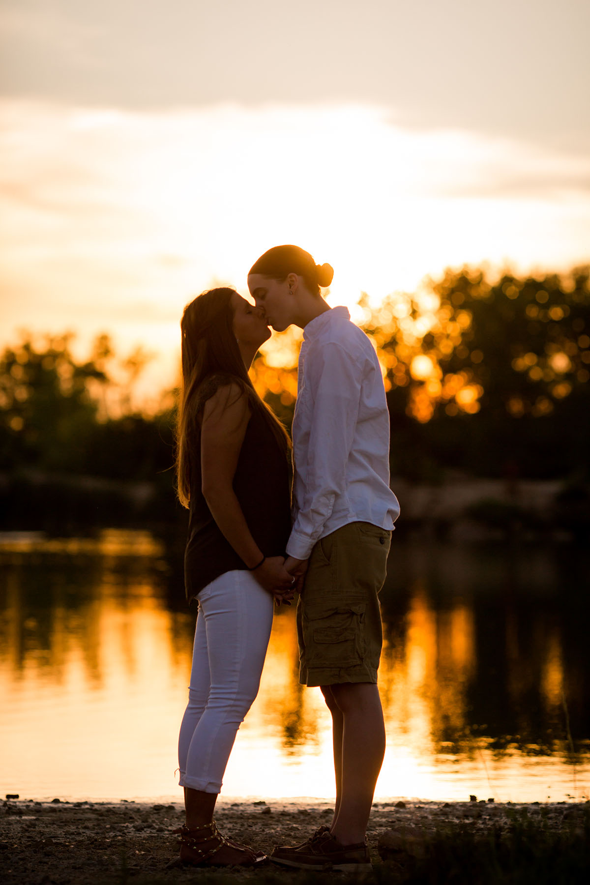 Sunset family portraits by the lake kiss