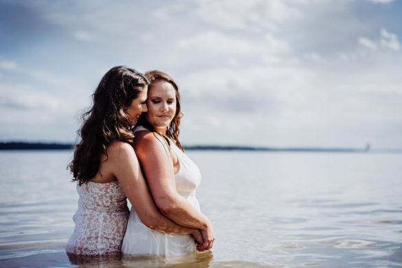 Two brides trash their wedding dresses in a styled shoot water embrace