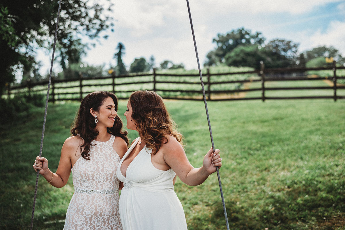 Two brides trash their wedding dresses in a styled shoot swings