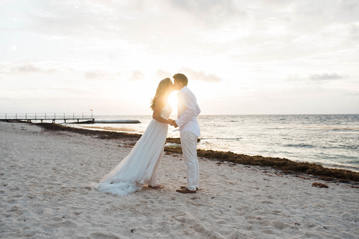 Cancun resort lesbian destination beach wedding Rachel Campbell Equally Wed brides kissing