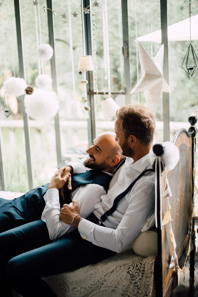 grooms in bed Italian rustic moody destination gay wedding of your dreams Serena Genovese, photographer Equally Wed LGBTQ weddings
