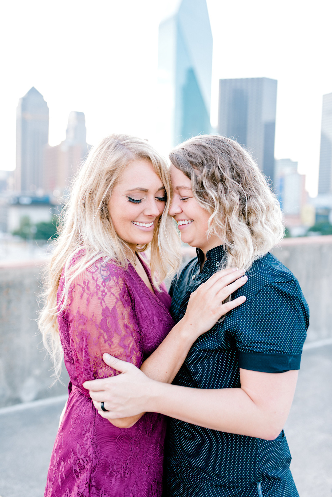 Bright, floral engagement session in downtown Dallas, Texas two blonde brides ring casual sunrise jeans red lace dress heels boots skyline