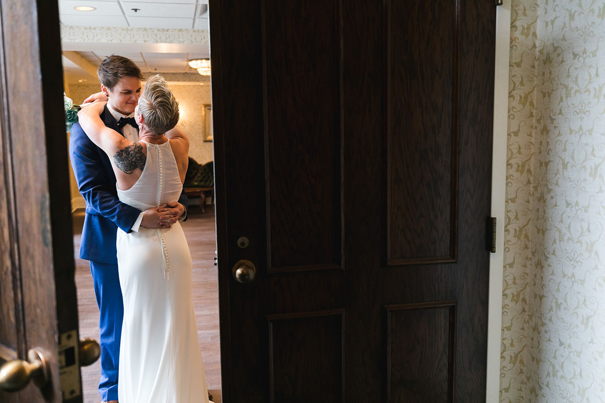 Classy, modern Friday night wedding two brides Minneapolis blue tuxedo white dress short hair dance