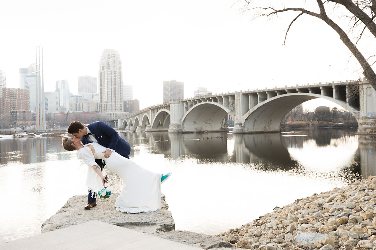 Classy, modern Friday night wedding two brides Minneapolis blue tuxedo white dress short hair dip skyline