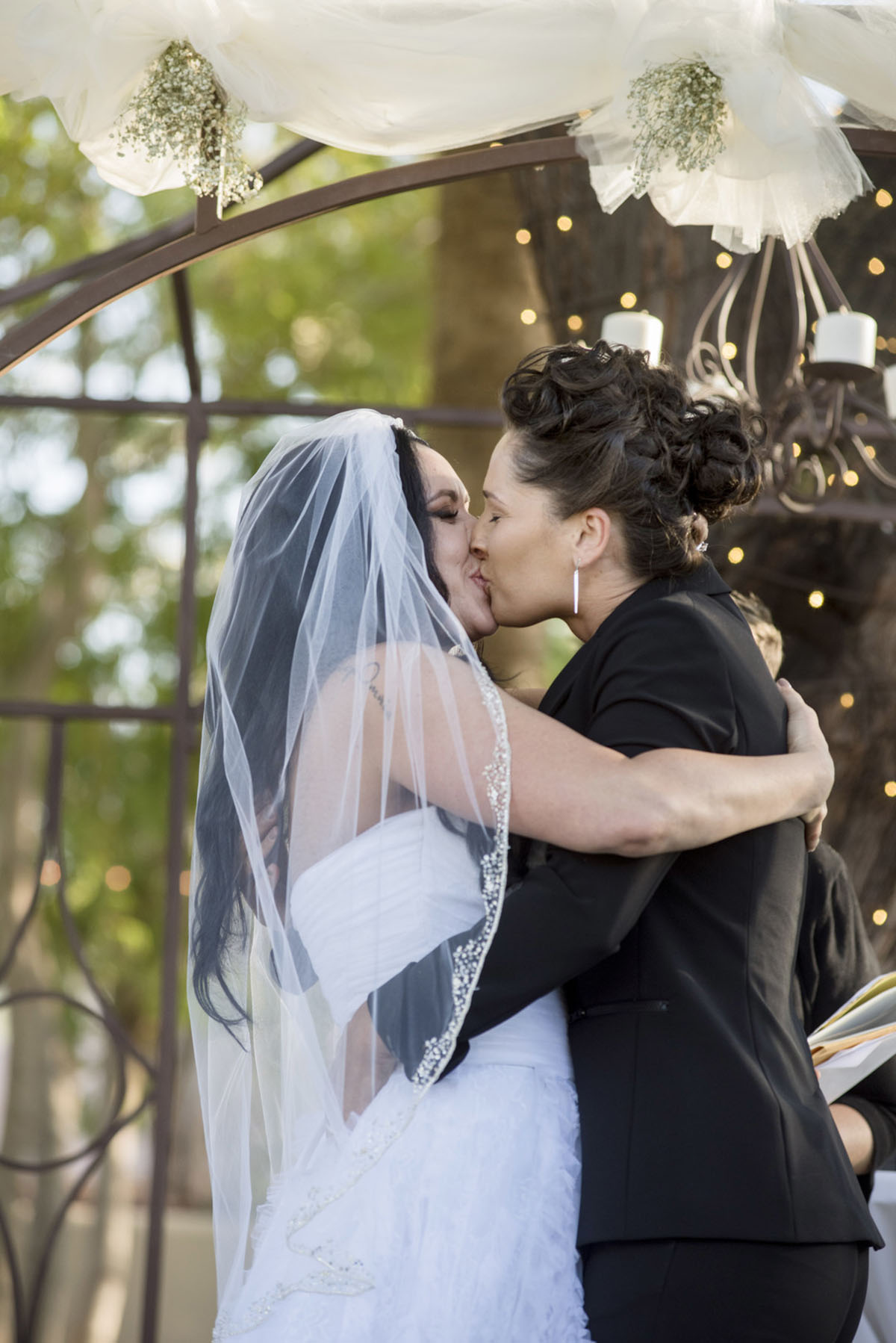 Colorful, sophisticated Latin wedding in Phoenix, Arizona two brides black tuxedo white dress kiss
