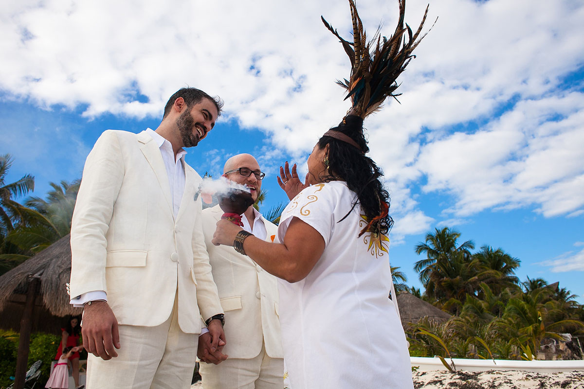 Destination Mexican beach wedding at Akiin Tulum two grooms white suits tuxedos ceremony