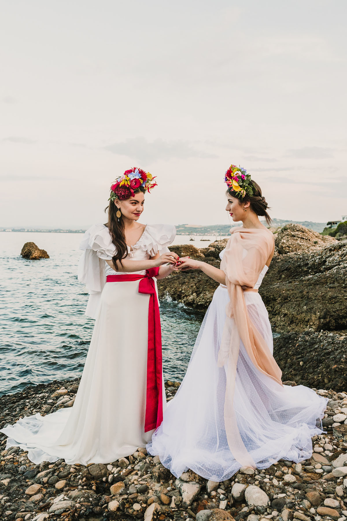 Eclectic colorful Frida Kahlo beach wedding inspiration two bridges big bouquets bright flowers classic white dresses