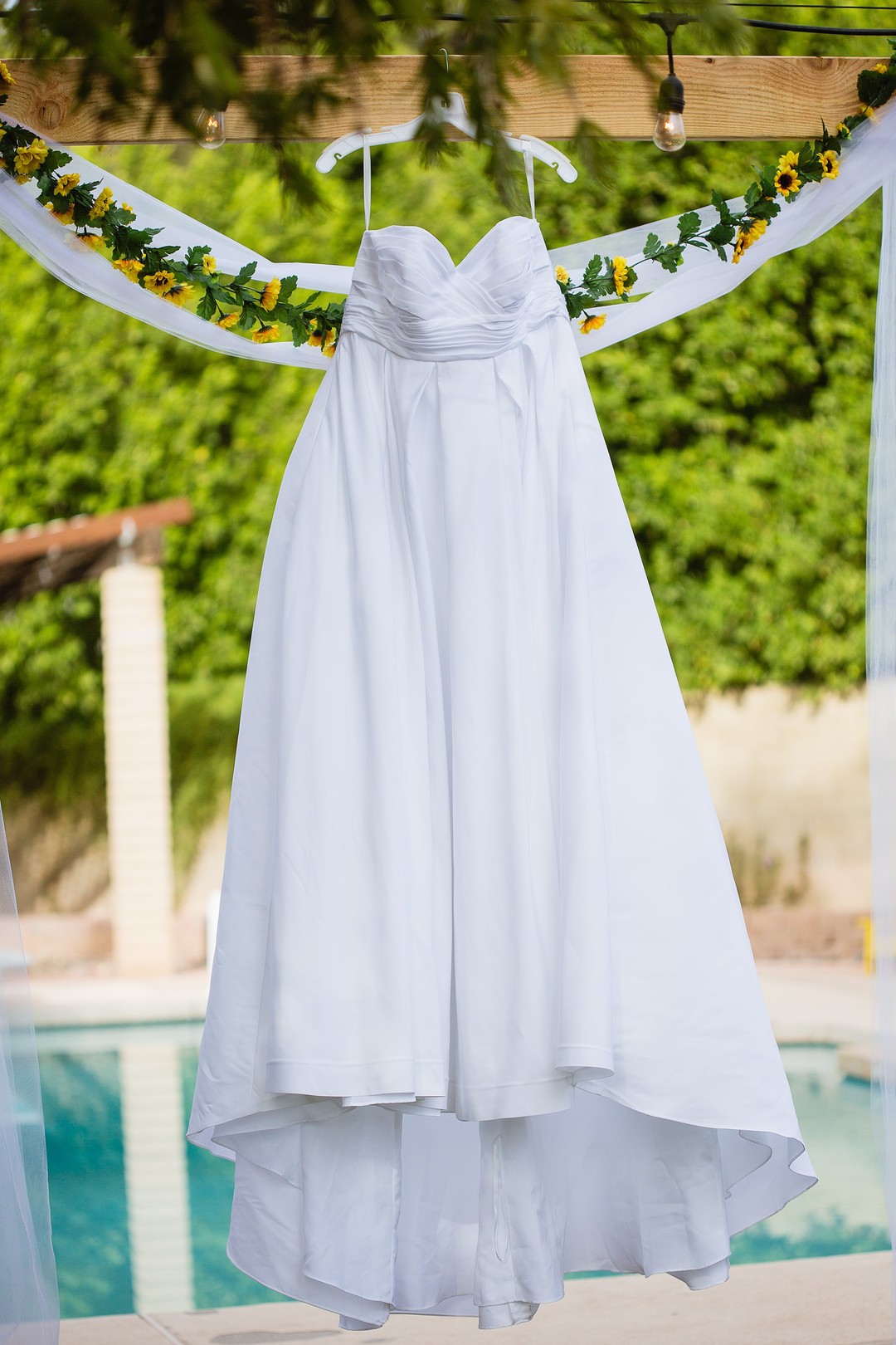 Fun and romantic Arizona backyard wedding white dress hanging