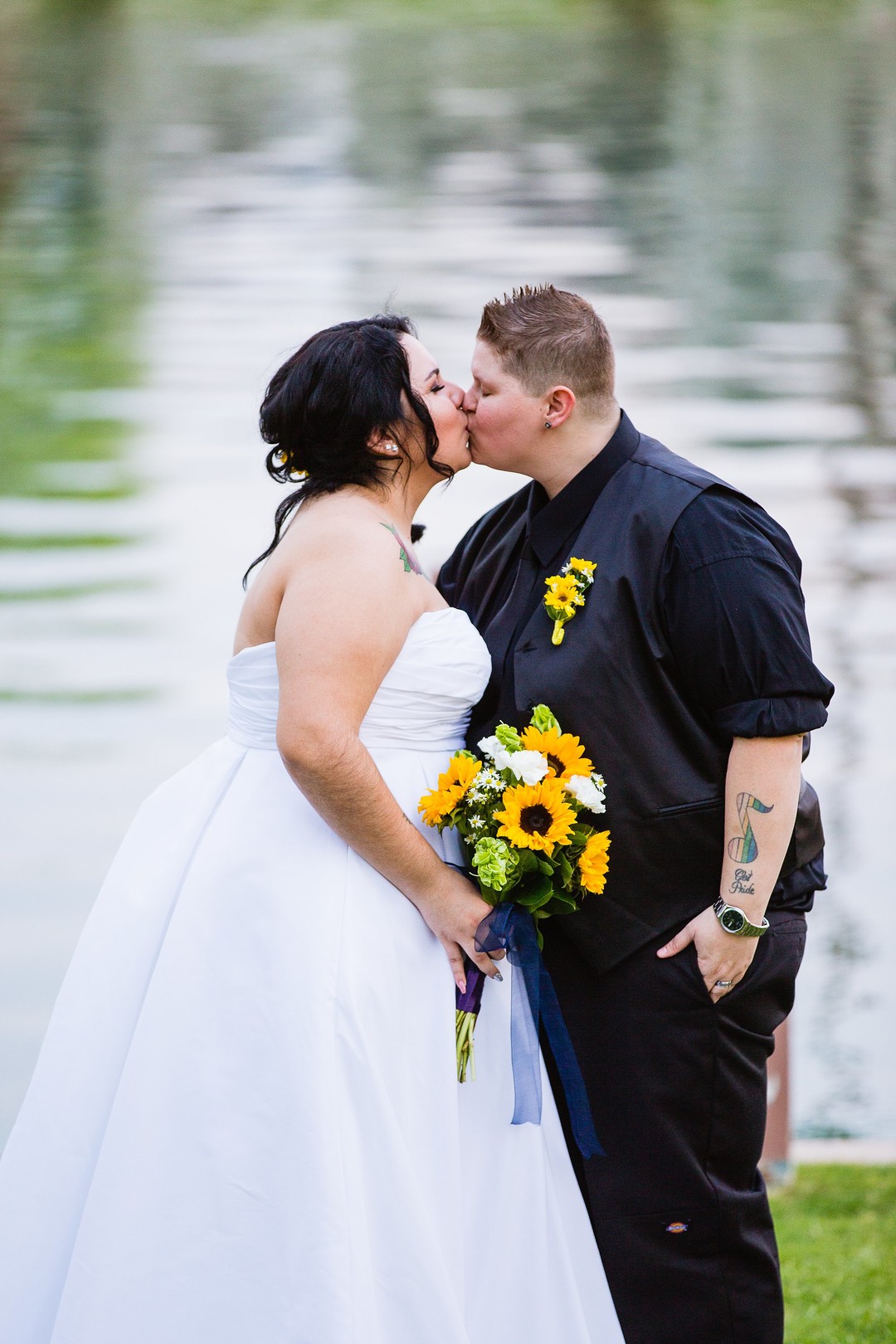 Fun and romantic Arizona backyard wedding sunflowers bouquet black tuxedo white dress lake