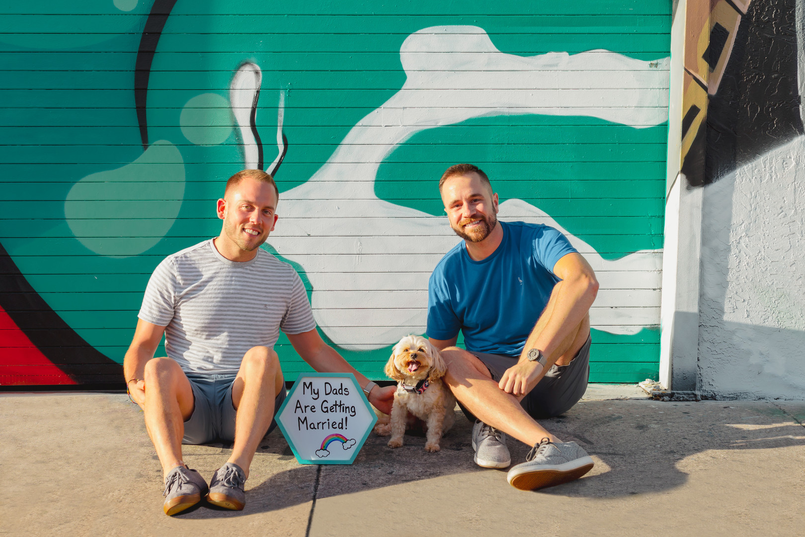 Fun, colorful arcade engagement photos two grooms street art Miami, Florida art district graffiti casual dog dads