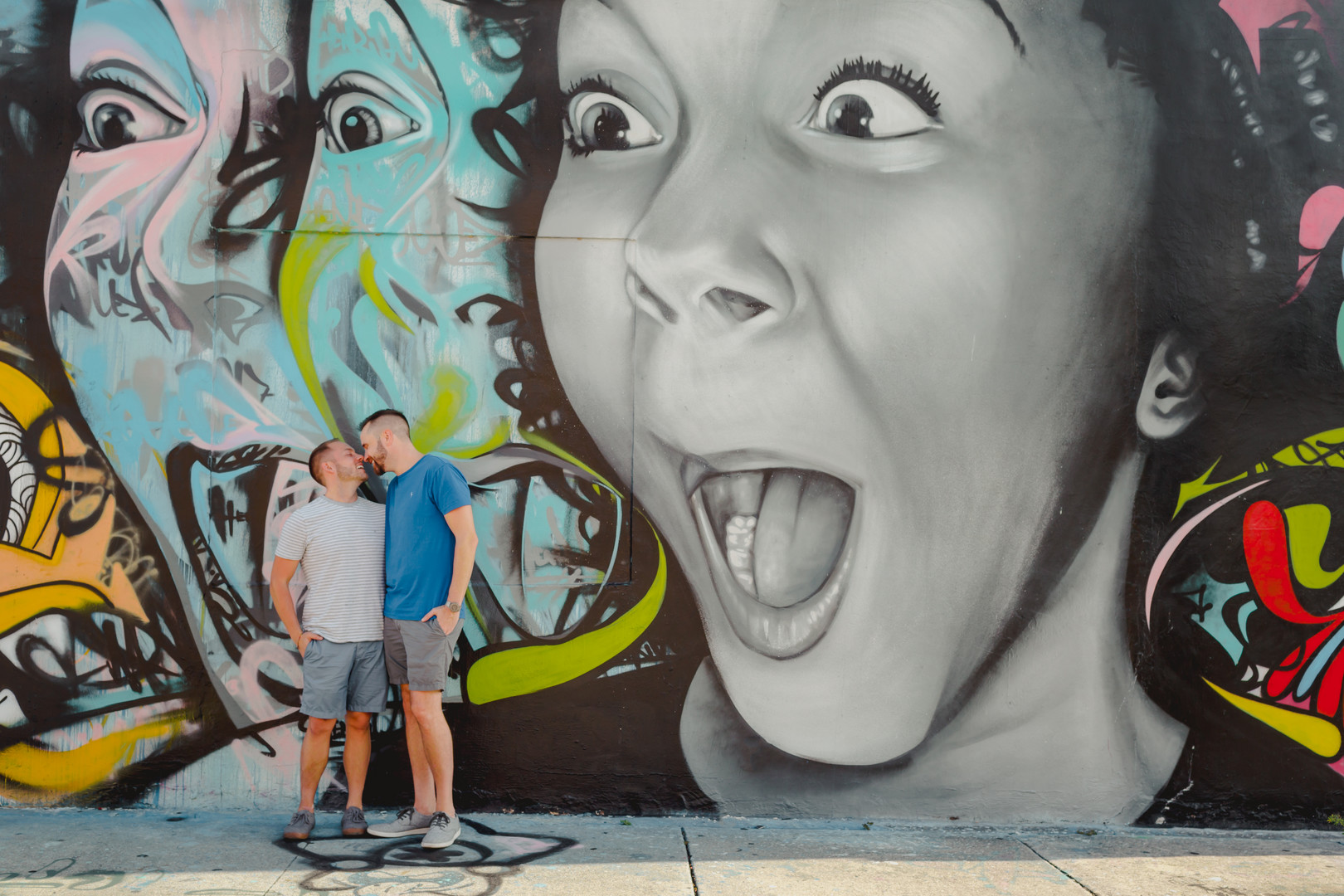 Fun, colorful arcade engagement photos two grooms street art Miami, Florida art district graffiti casual