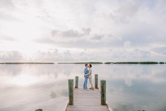 Intimate Florida Keys tropical wedding two grooms blue tan tuxedo pier water beach kiss