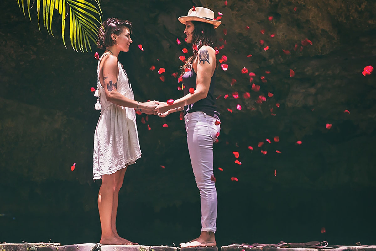 Mystical surprise proposal inside a Mexican cenote two brides Mexico tattoos jungle rose petals