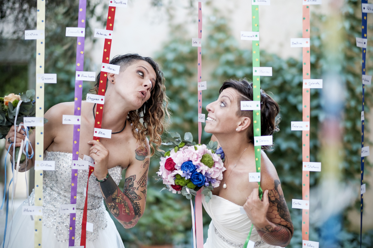 Rainbow Italian wedding in Cagliari two brides colorful bright colors short hair white dresses