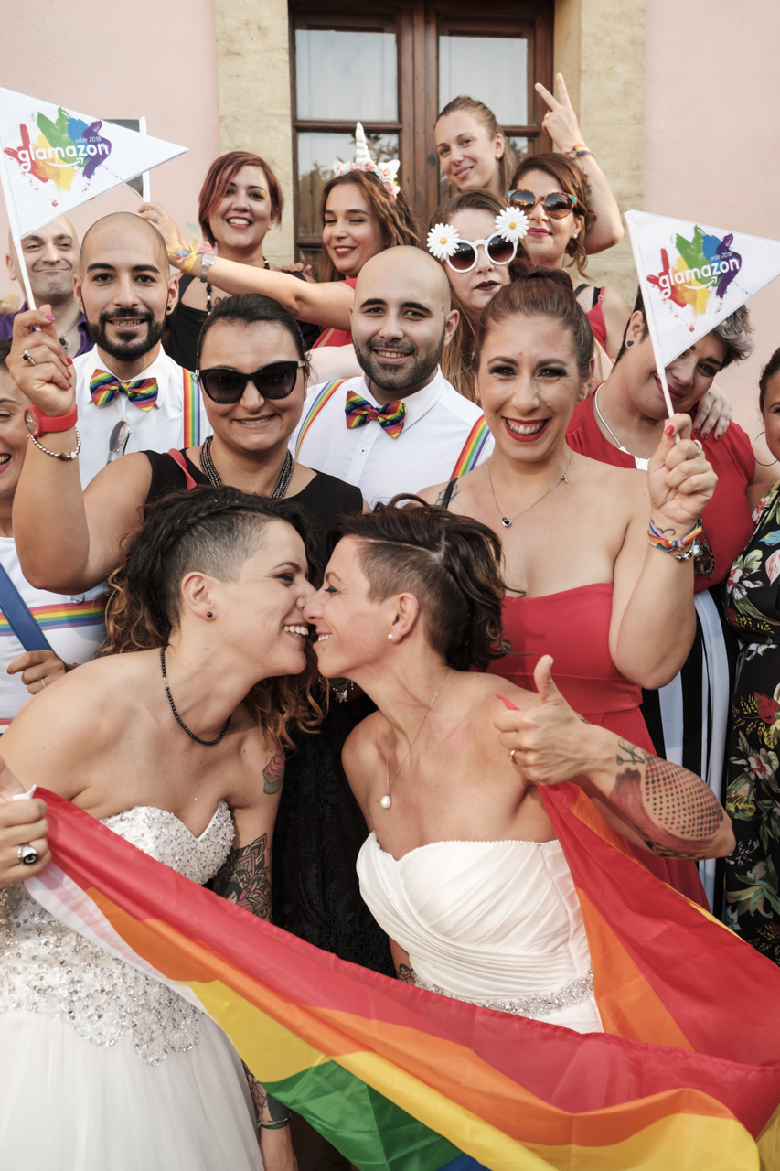 Rainbow Italian wedding in Cagliari two brides colorful bright colors short hair white dresses friends family celebration