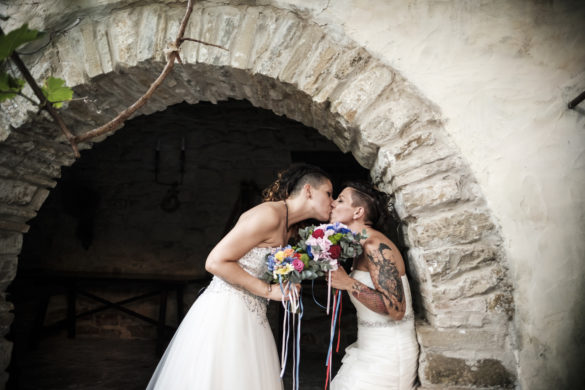 Rainbow Italian wedding in Cagliari two brides colorful bright colors short hair white dresses kiss bouquet