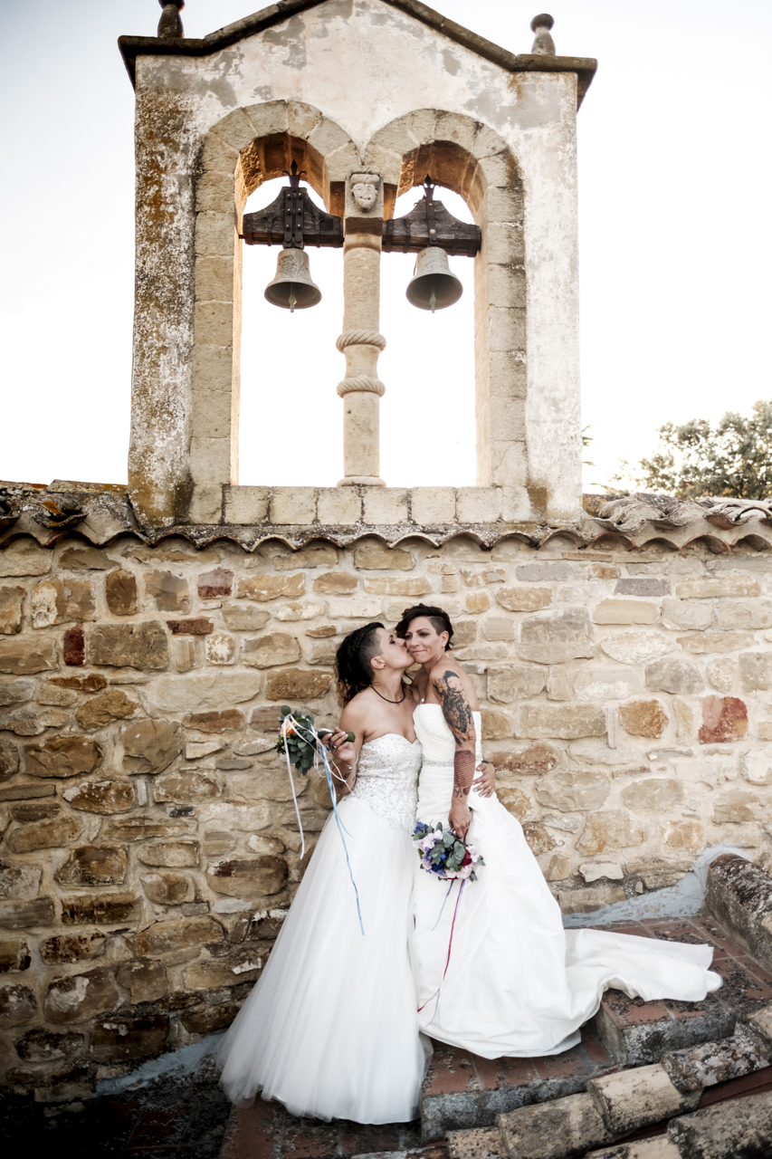 Rainbow Italian wedding in Cagliari two brides colorful bright colors short hair white dresses bell tower