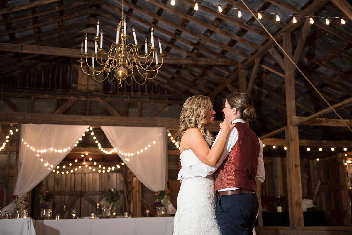 Rustic traditional Southern fall wedding in a barn veil white dress cowboy boots vest Saint Louis two brides first dance