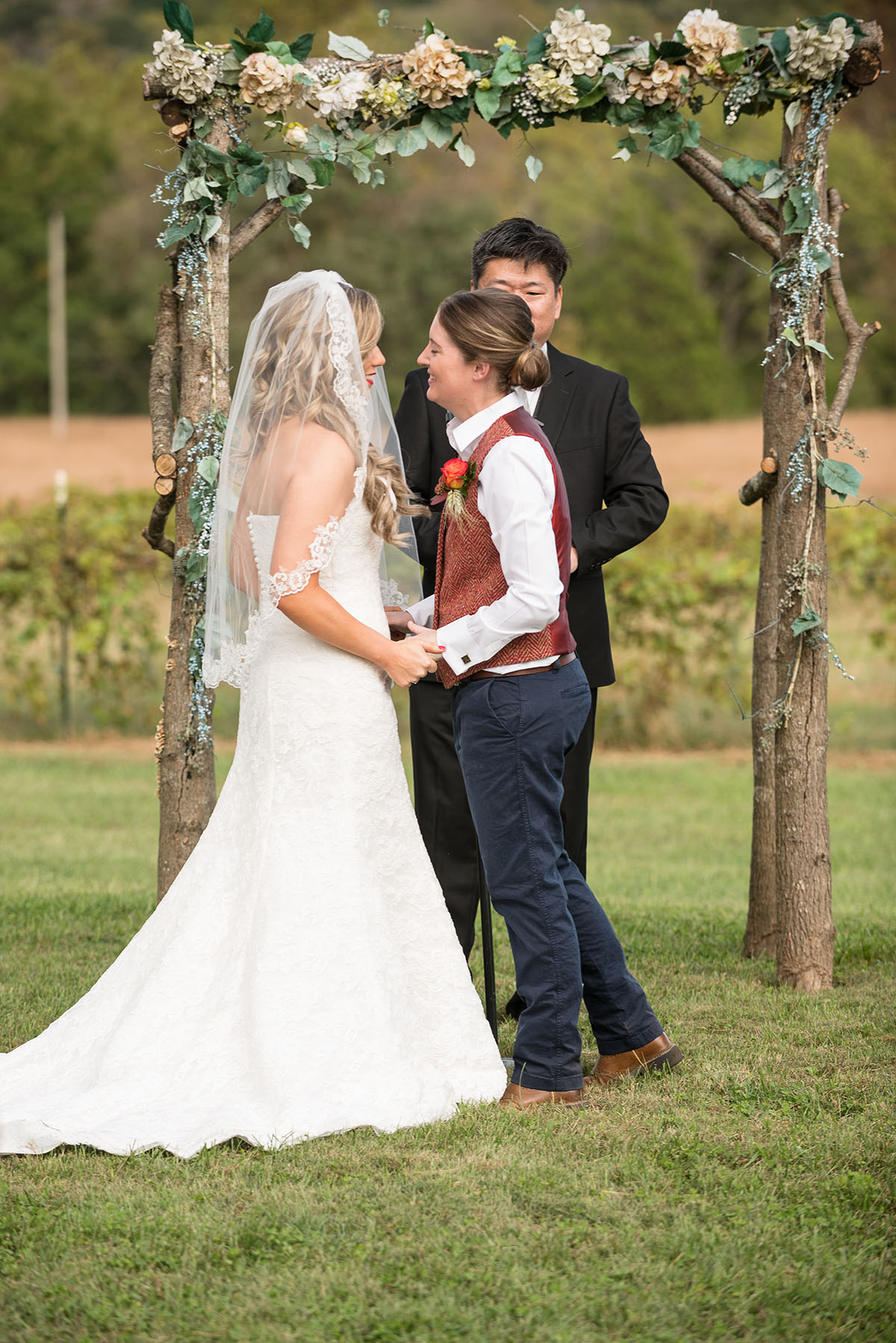 Rustic traditional Southern fall wedding in a barn veil white dress cowboy boots vest Saint Louis two brides