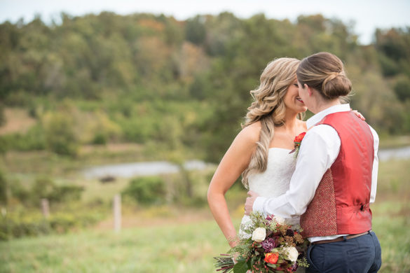 Rustic traditional Southern fall wedding in a barn veil white dress cowboy boots vest Saint Louis two brides kiss
