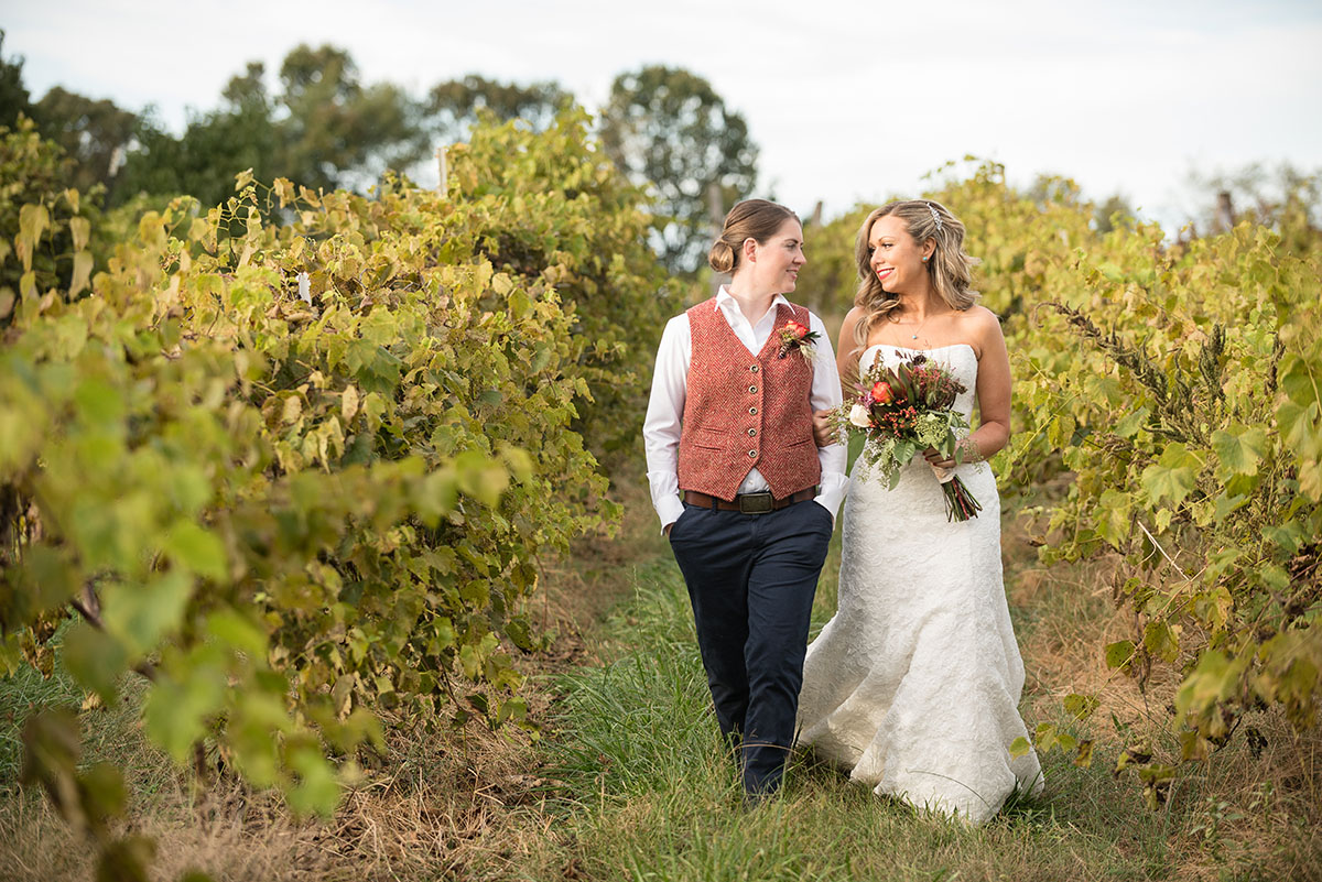 Rustic traditional Southern fall wedding in a barn veil white dress cowboy boots vest Saint Louis two brides flowers field