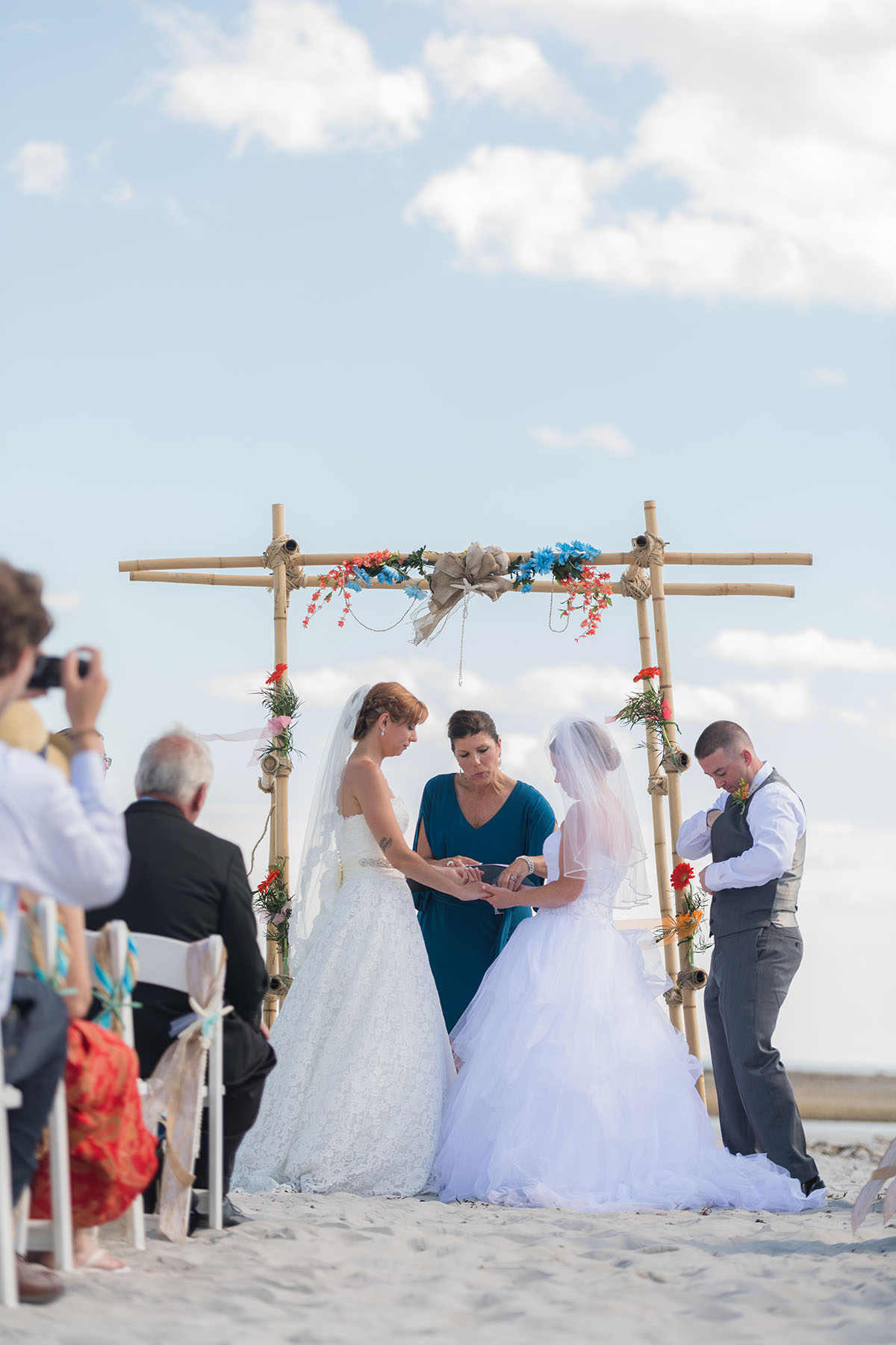 Beach wedding in Kennebunkport, Maine two brides long white dresses summer bouquets vows