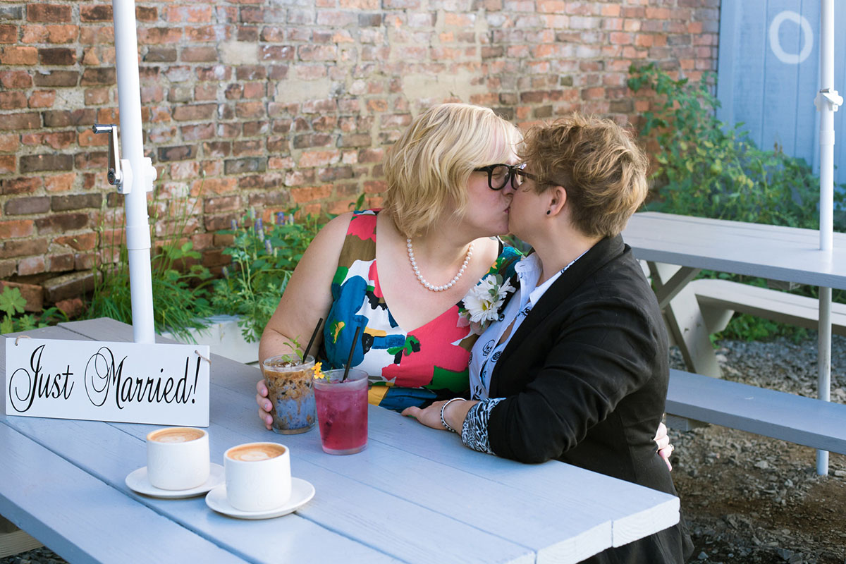 Cozy courthouse wedding with coffeehouse reception two brides colorful Modcloth dress glasses black blazer hipster