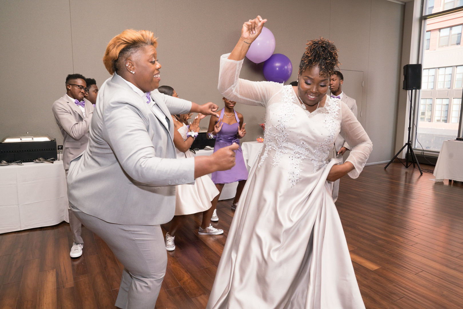 Fun purple and silver wedding in Bethesda, Maryland two brides lesbian long sleeve wedding dress silver tuxedo dancing