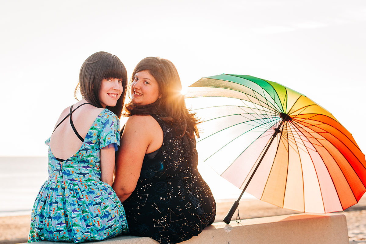 I proposed to my high school sweetheart—here's how we make it work two brides lesbian couple beach engagement books literature Harry Potter rainbow umbrella