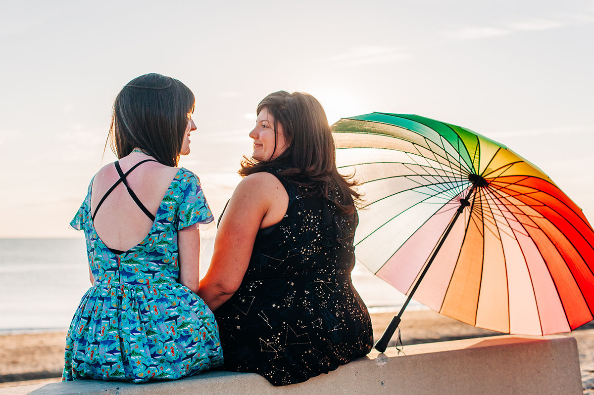 I proposed to my high school sweetheart—here's how we make it work two brides lesbian couple beach engagement books literature Harry Potter rainbow umbrella