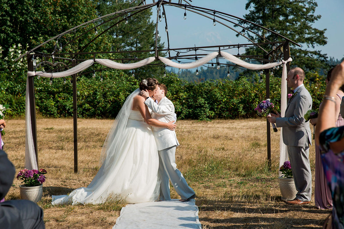 Purple Northwest backyard wedding two brides white dress white tuxedo vows just married