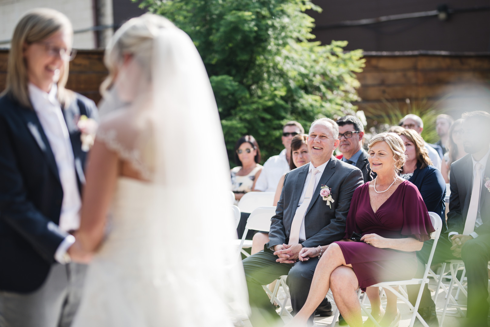 Rustic wedding in Columbus, Ohio two brides long white dress black suit outside vows