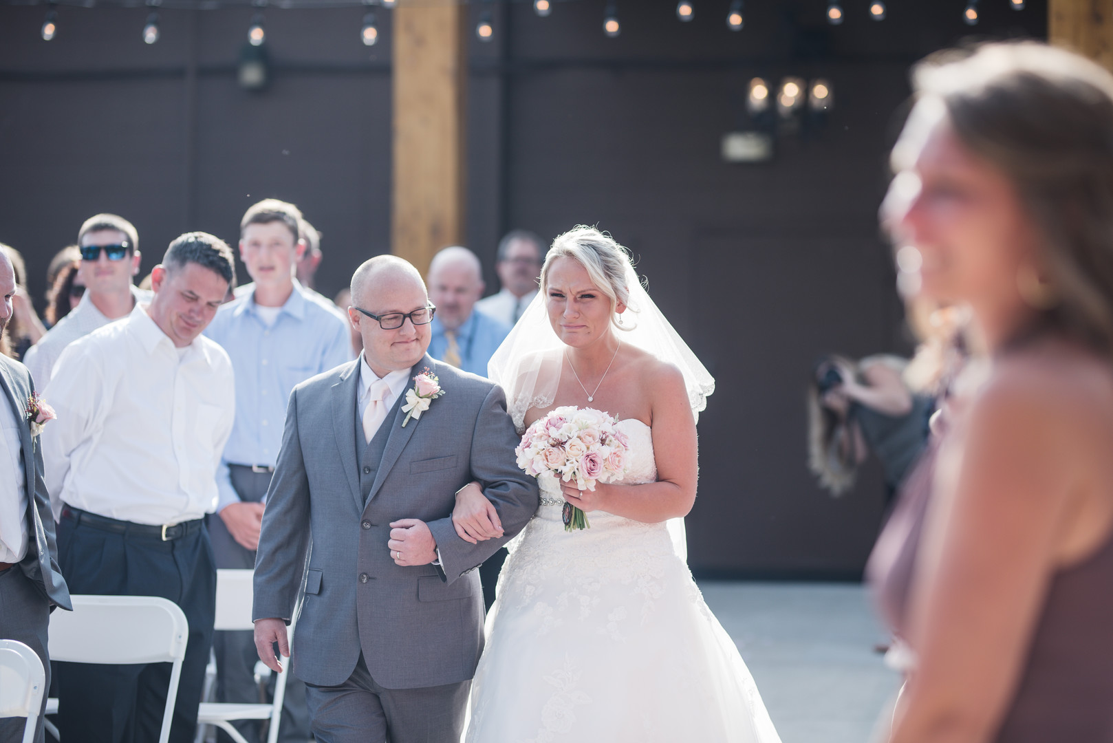 Rustic wedding in Columbus, Ohio two brides long white dress black suit outside first look