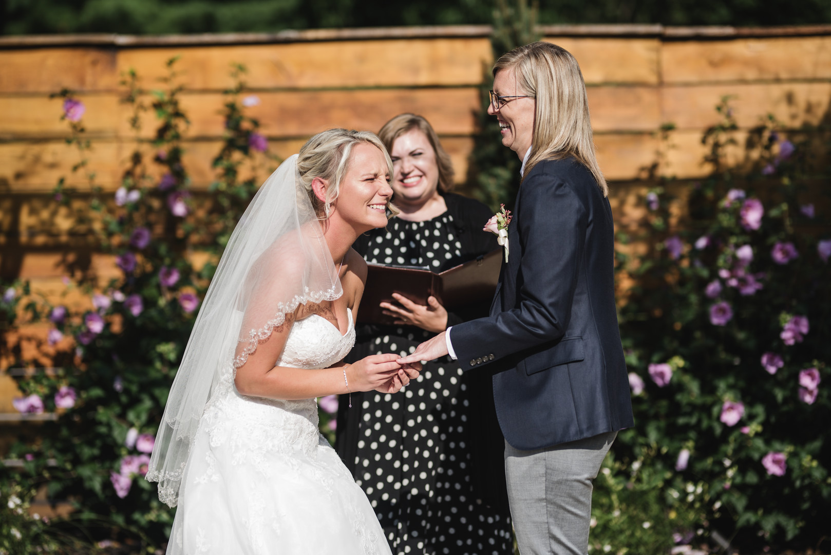 Rustic wedding in Columbus, Ohio two brides long white dress black suit outside vows
